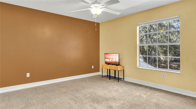 spare room featuring carpet floors and ceiling fan