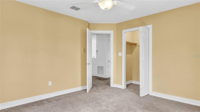 unfurnished bedroom with ceiling fan, light colored carpet, and a closet