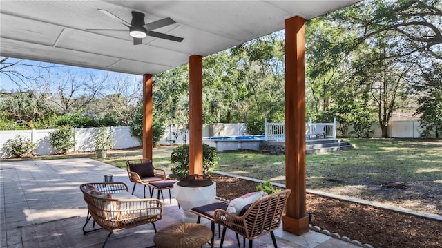 view of patio featuring a fenced in pool and ceiling fan