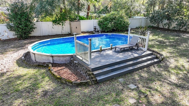 view of swimming pool with a deck