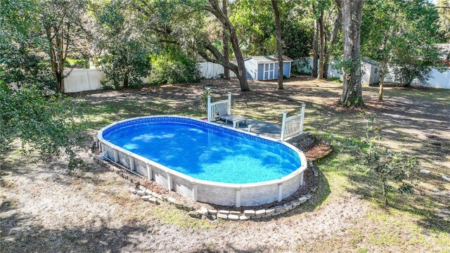 view of swimming pool featuring a shed