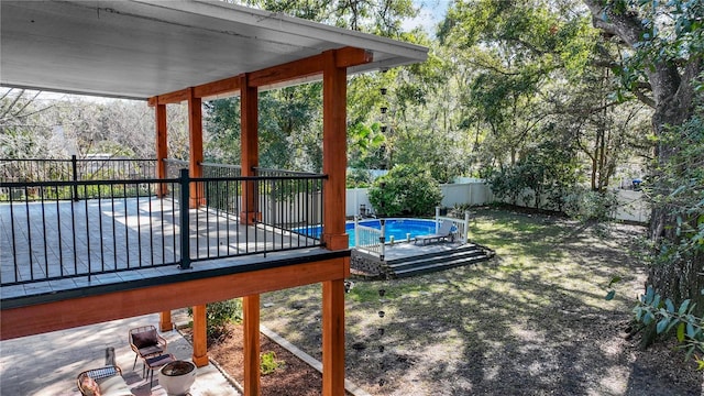 view of yard with a swimming pool side deck