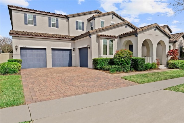 mediterranean / spanish-style house with a garage