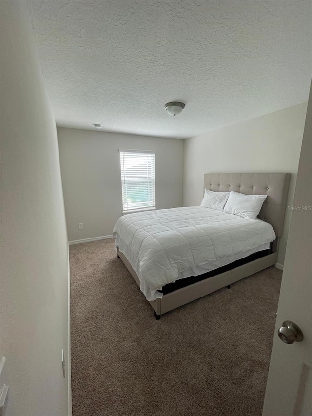 carpeted bedroom with a textured ceiling