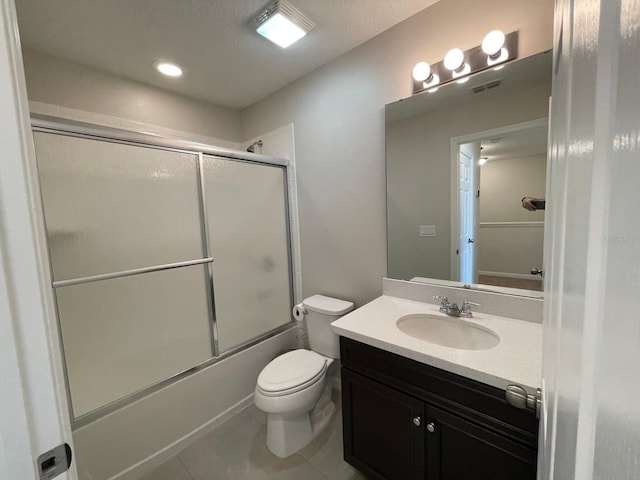 full bathroom featuring bath / shower combo with glass door, vanity, toilet, and tile patterned flooring