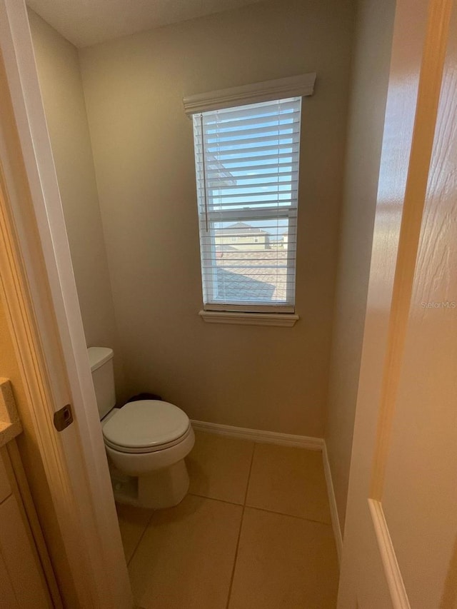 bathroom with tile patterned flooring and toilet