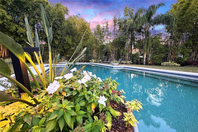 view of pool at dusk