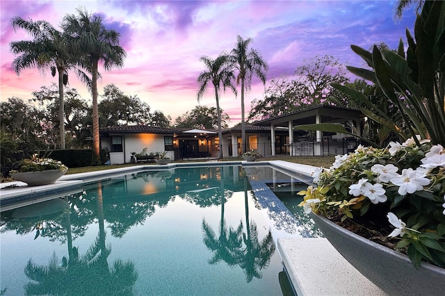 view of pool at dusk