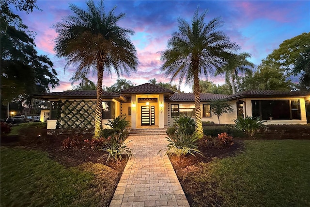 mediterranean / spanish-style home featuring a lawn