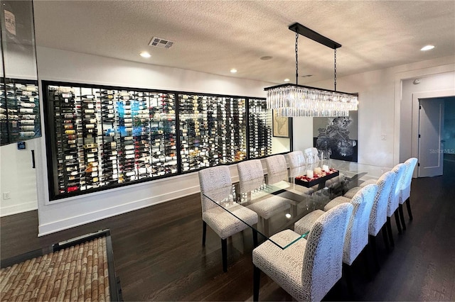 dining room featuring dark hardwood / wood-style floors and a textured ceiling