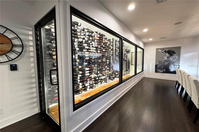 wine area with dark hardwood / wood-style floors