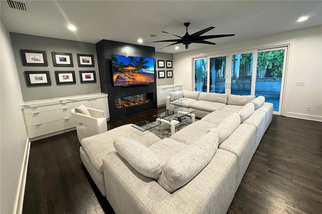 living room with dark wood-type flooring and ceiling fan