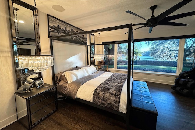 bedroom with dark hardwood / wood-style flooring