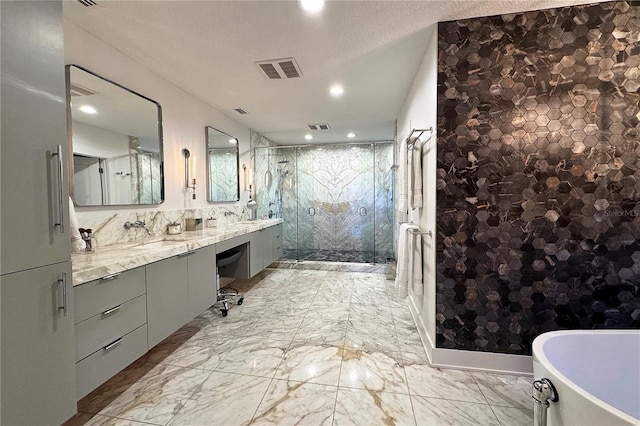 bathroom featuring vanity, independent shower and bath, and a textured ceiling