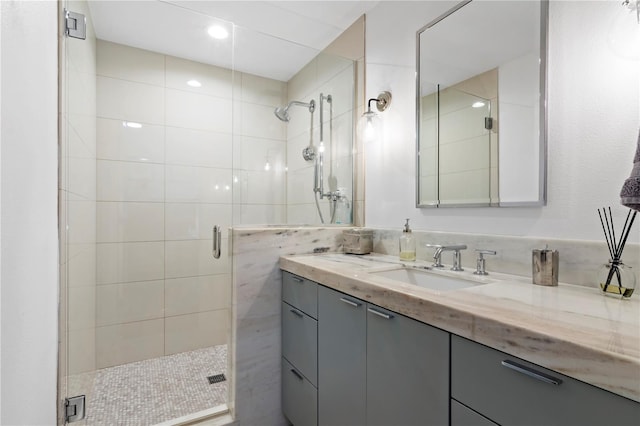 bathroom featuring vanity and a shower with door