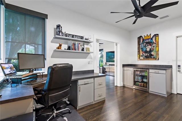 office with ceiling fan, indoor bar, beverage cooler, and dark hardwood / wood-style flooring