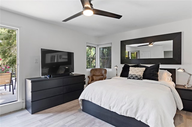 bedroom with multiple windows, access to outside, ceiling fan, and light wood-type flooring