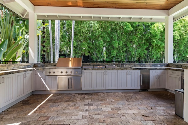 view of patio featuring an outdoor kitchen, a grill, and sink