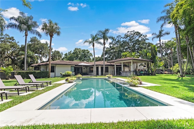 view of swimming pool with a yard and a patio