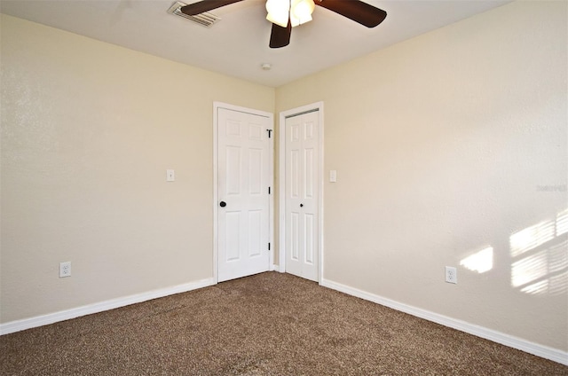 empty room featuring ceiling fan and carpet flooring