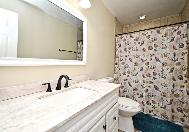 bathroom with a shower with curtain, vanity, and toilet