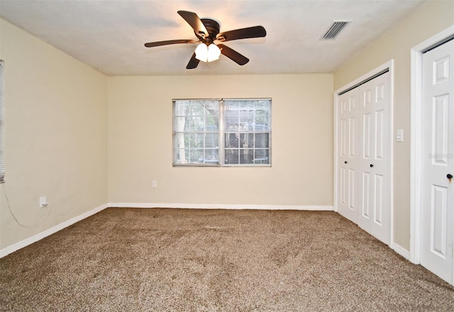 unfurnished bedroom featuring carpet, ceiling fan, and a closet