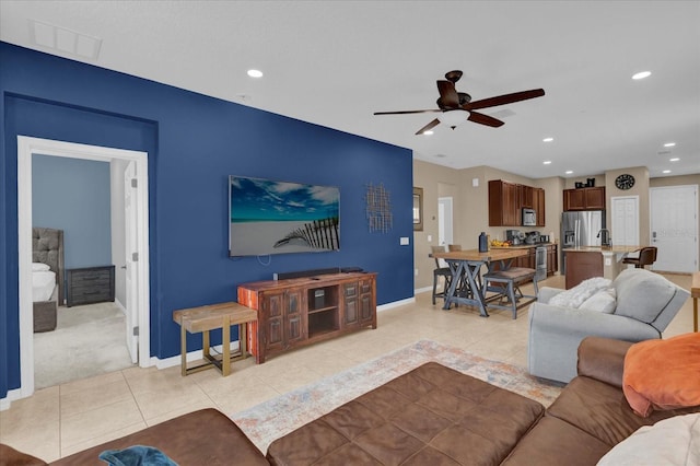 living room with ceiling fan and light tile patterned flooring