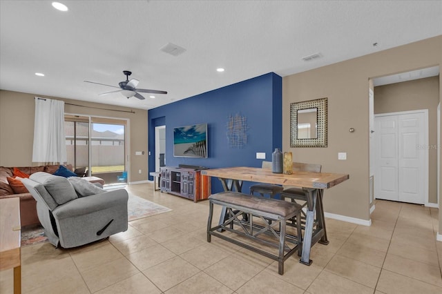 tiled living room featuring a textured ceiling and ceiling fan