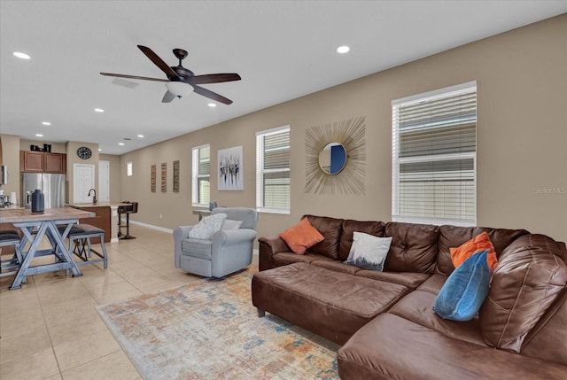 tiled living room with ceiling fan