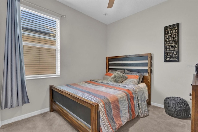 bedroom featuring ceiling fan and light carpet