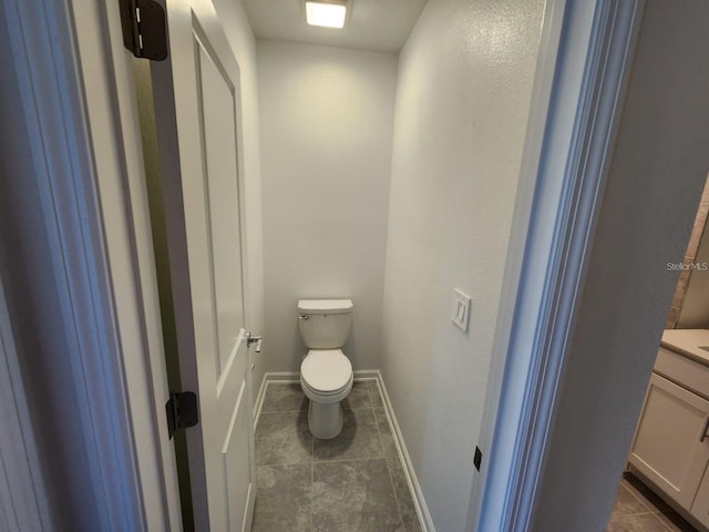 bathroom with vanity, tile patterned floors, and toilet