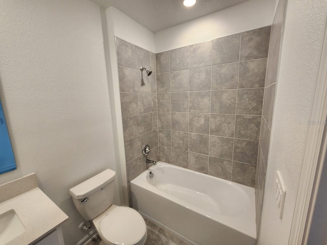 full bathroom with tiled shower / bath, vanity, and toilet