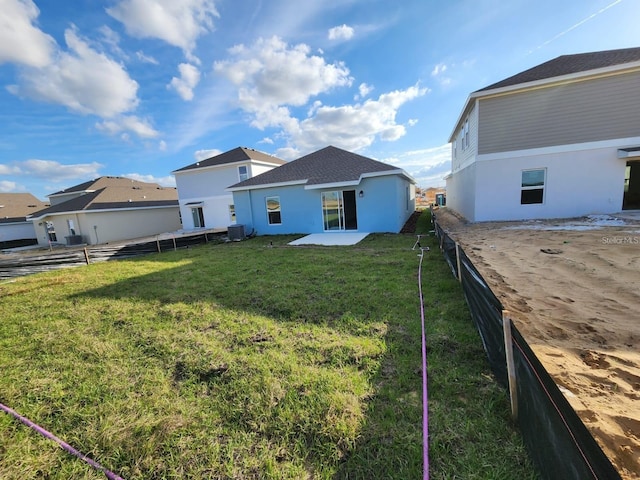 back of property featuring a patio area, central AC, and a lawn