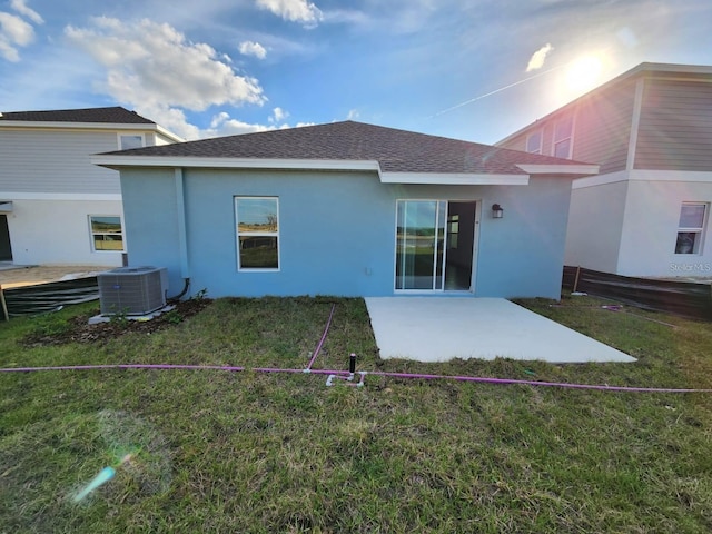 back of house featuring a lawn, a patio, and central air condition unit