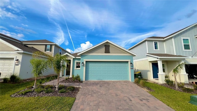 view of front facade with a garage, decorative driveway, and stucco siding