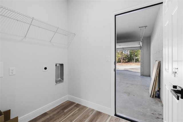 laundry area featuring hardwood / wood-style flooring and electric dryer hookup