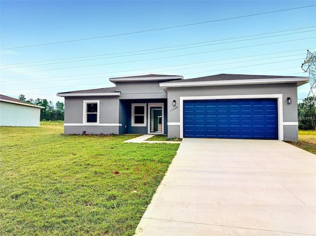 prairie-style house with a garage and a front lawn