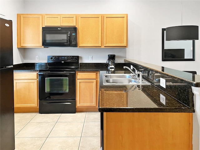 kitchen with dark stone counters, sink, black appliances, and light tile patterned floors