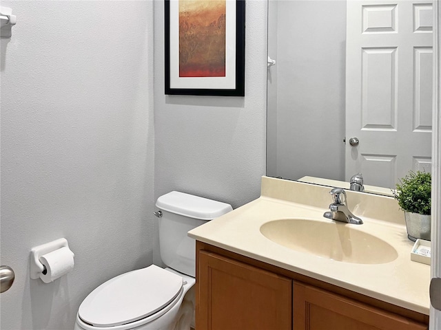 bathroom featuring toilet and vanity