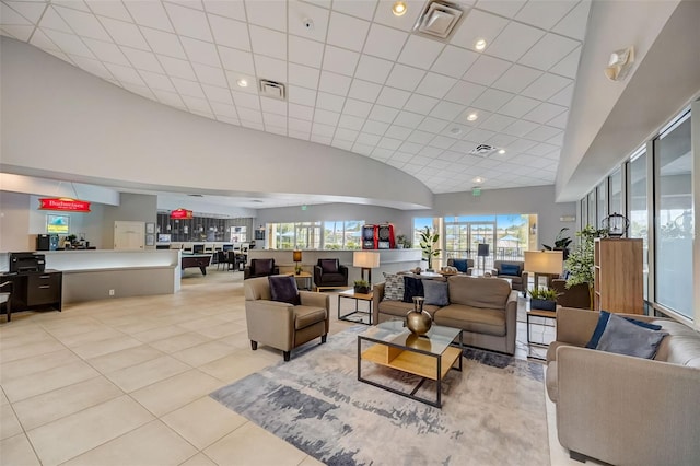 tiled living room featuring high vaulted ceiling