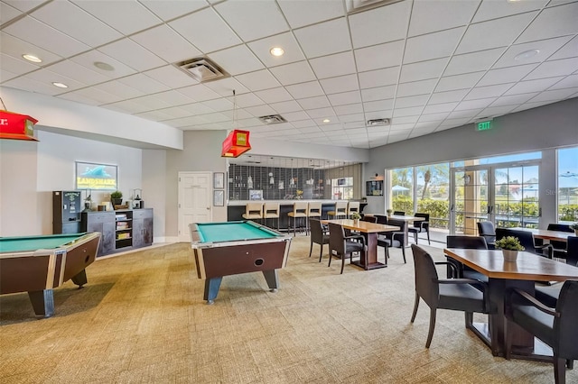 recreation room with pool table, a paneled ceiling, and light colored carpet