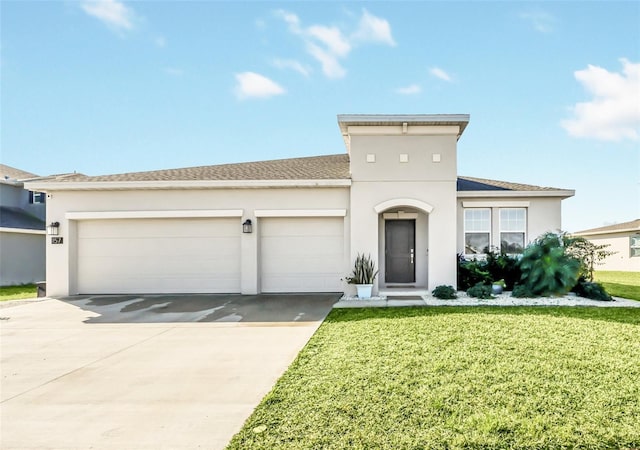 view of front of property with a garage and a front lawn