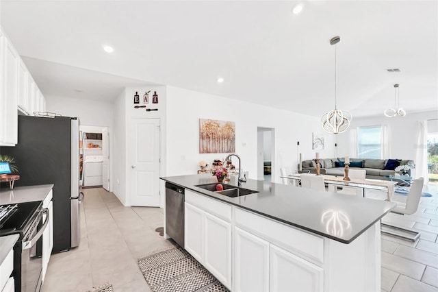 kitchen featuring stainless steel appliances, sink, a center island with sink, and white cabinets