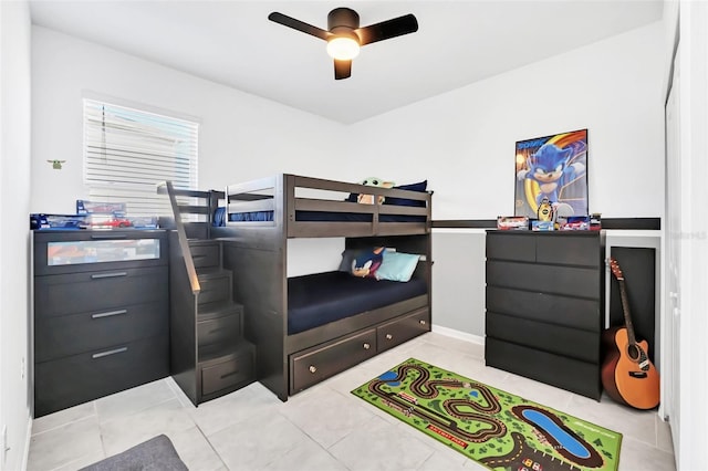 tiled bedroom featuring ceiling fan