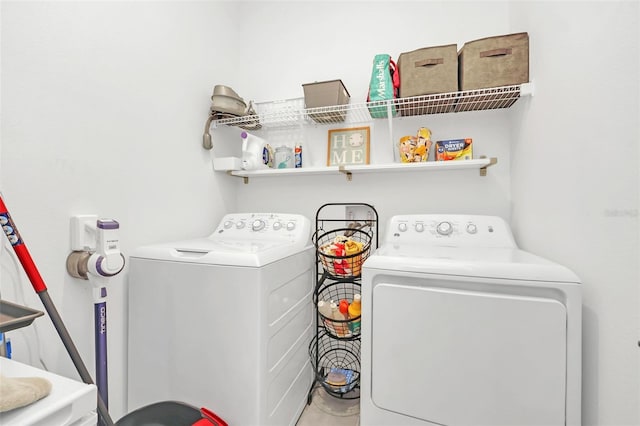 washroom with washing machine and clothes dryer