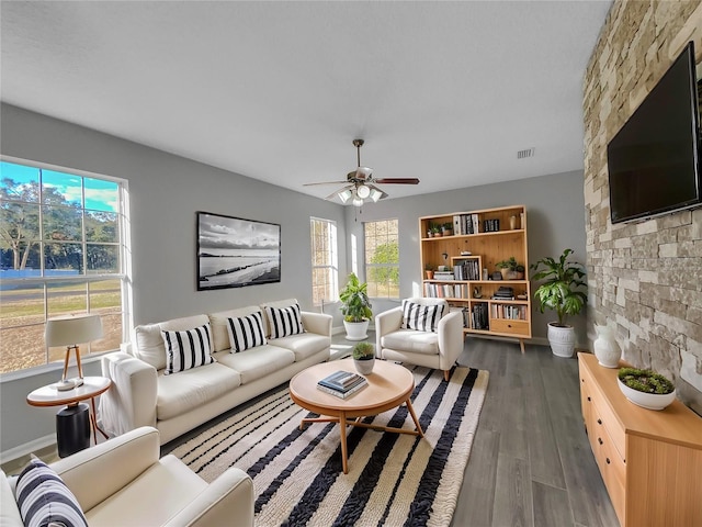 living room with dark hardwood / wood-style floors and ceiling fan