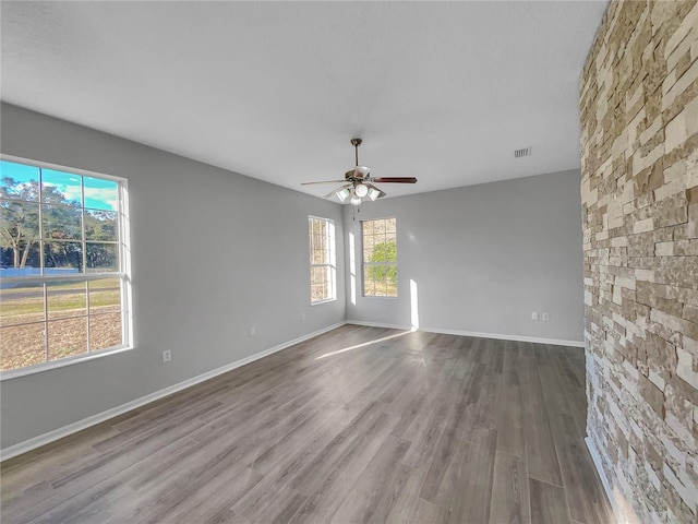 unfurnished room with wood-type flooring and ceiling fan