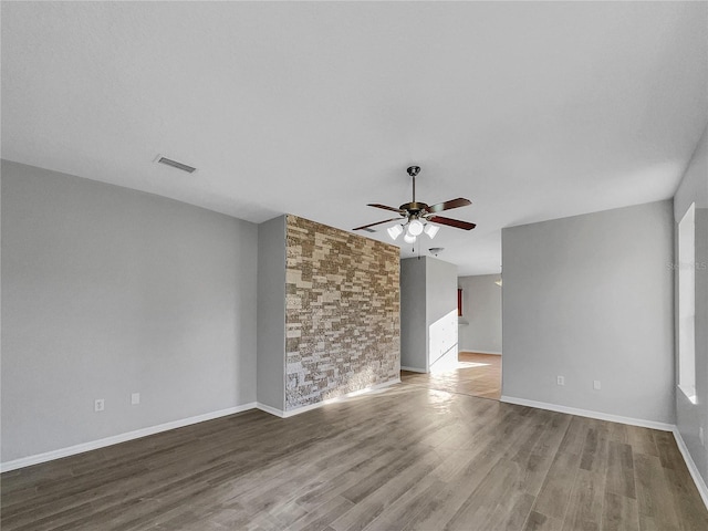 unfurnished living room featuring hardwood / wood-style flooring and ceiling fan