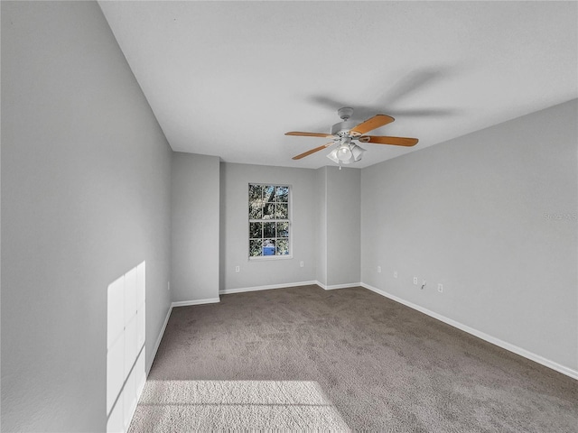 unfurnished room featuring ceiling fan and carpet