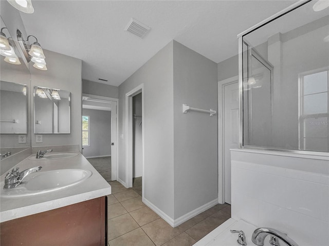 bathroom featuring tile patterned flooring, vanity, and an enclosed shower